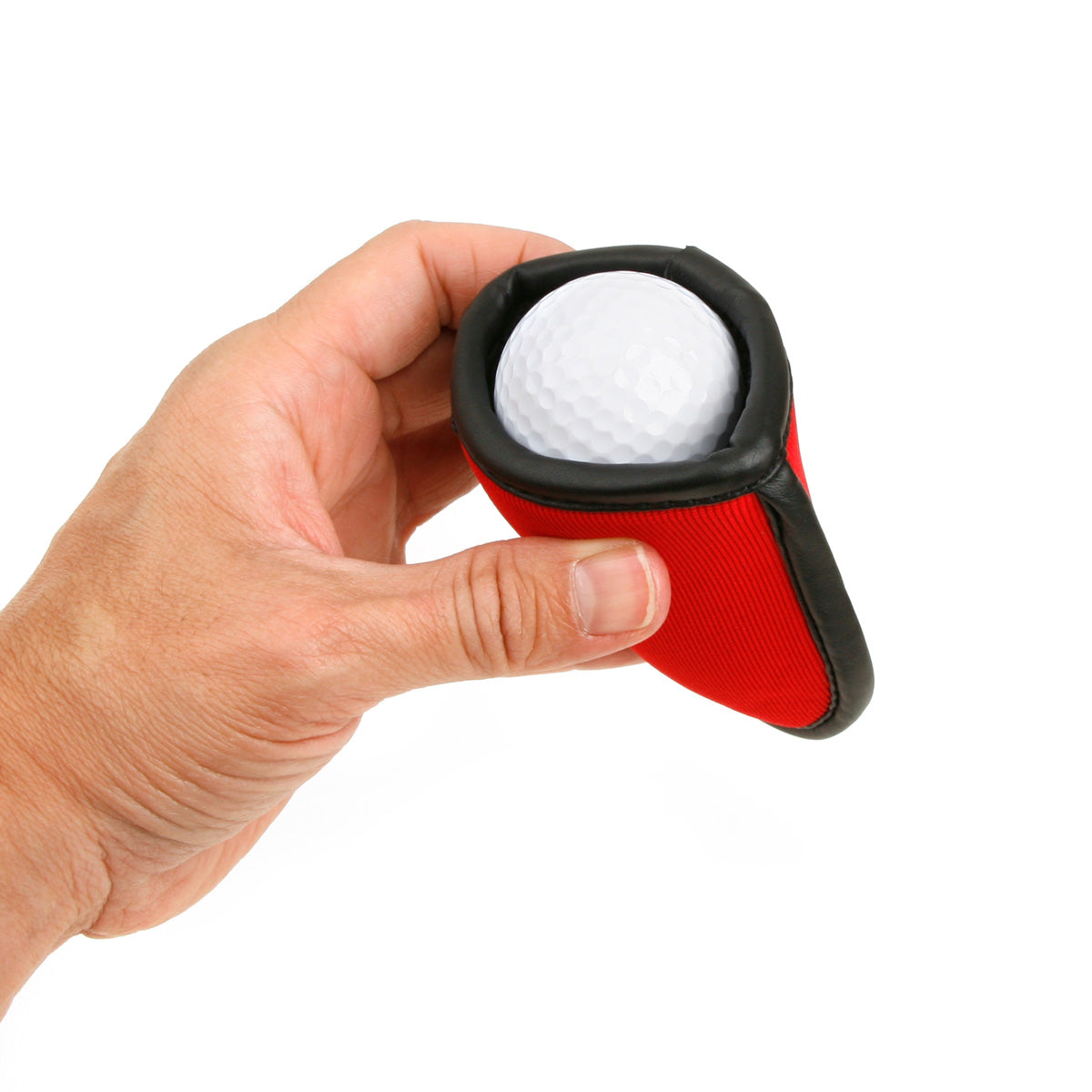 person holding a red Intech Squeaky Clean Pocket Golf Ball Washer with clean white golf ball inside