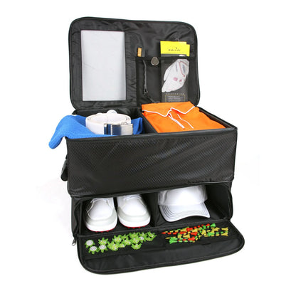front view of an opened Intech Double Row Golf Trunk Organizer with golf shoes, hat, white belt, orange golf shirt, golf glove and replacement spikes