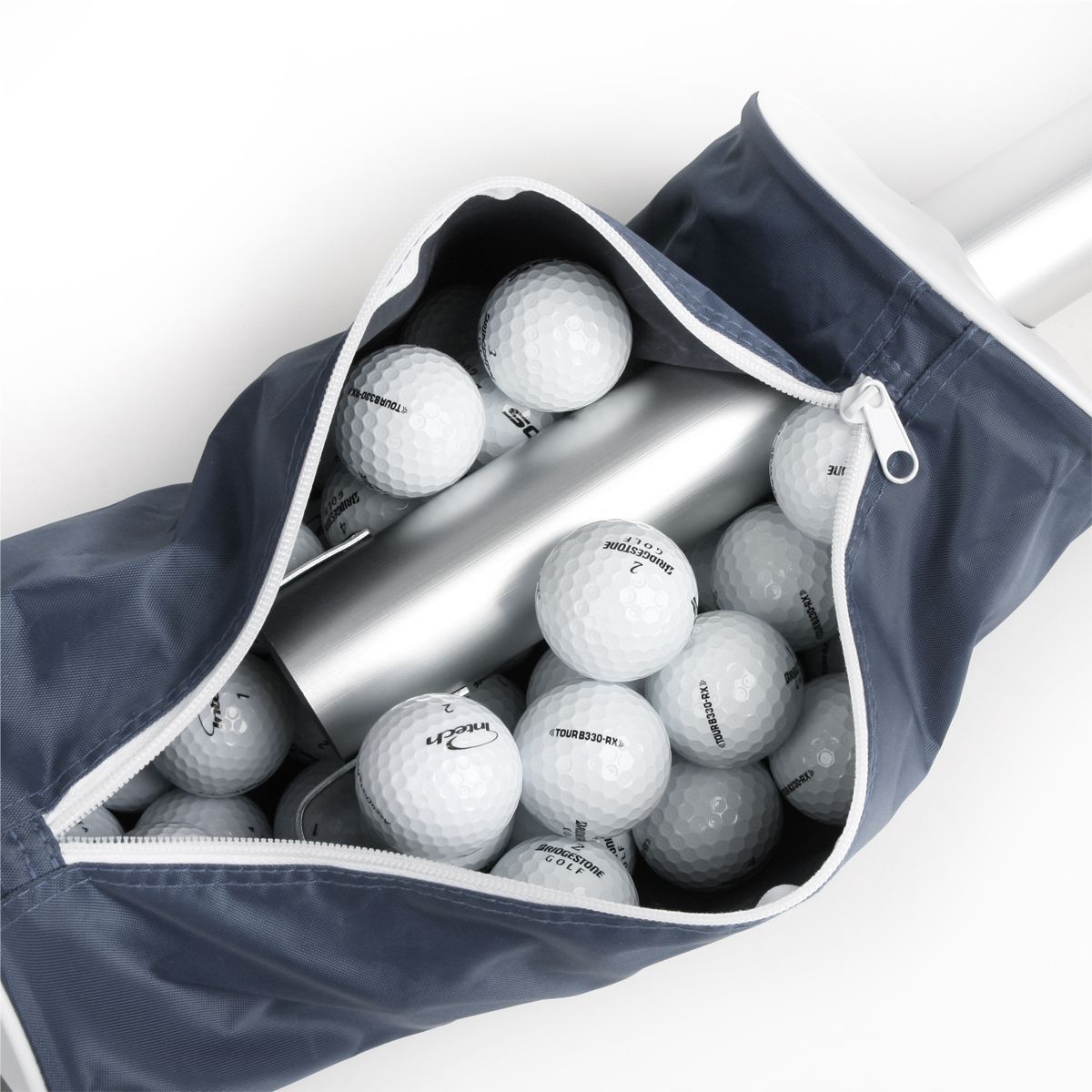 several golf balls inside the unzipped grey Intech Golf Ball Shag Bag